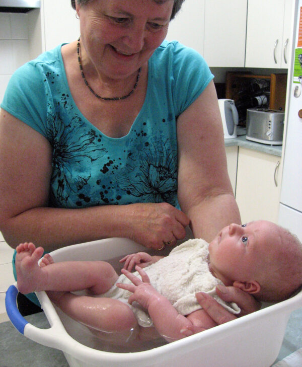 Coleen is photographed bathing her infant grandchild
