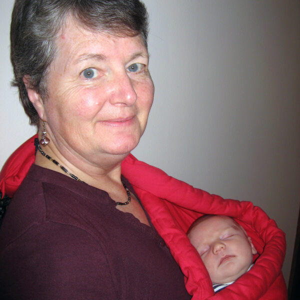 Coleen photographed holding her infant grandson in a sling