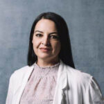 Photo of Rima Darwiche against a grey backdrop