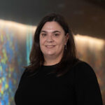 Photo of Kym Lowes with a light display in the background