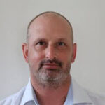 Photo of Nicolas Dzamko with a plain backdrop